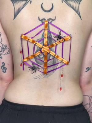 A post by @modsmeds on TikTok caption: 🕸️Spiderweb needle play🕸️ 🕷️24 piercings🕷️ 🎃Happy Halloween🎃 