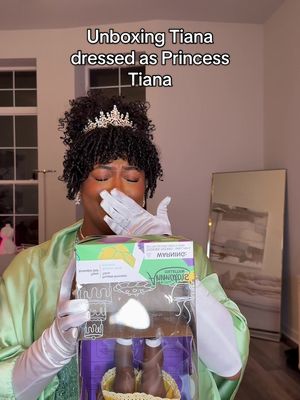 A post by @thatssoodrea on TikTok caption: Theres an imposter among us…💚👸🏾 #unboxing #princessandthefrog #princesstiana 