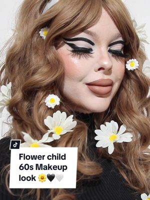 A post by @beatsbylizzie on TikTok caption: Flower child 60s vibes 🖤🤍🖤 using @Hindash liquid Liner and @Trixie Cosmetics White liquid shadow #flowerchild #60smakeup #60s  