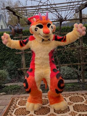 A post by @kilidathecat on TikTok caption: 🧡Destiny the Manokit 🧡 #germanfurry #furry #fursuit #fursuitcommission #fursuiter #manokit #fullsuit #furrytail #manokitfursuit 