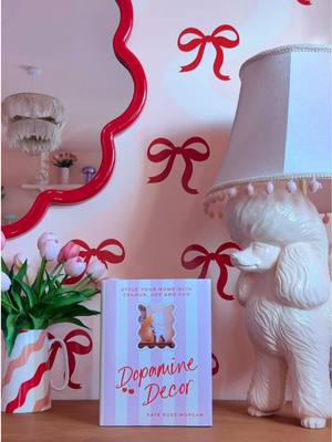 A post by @kate_rose_morgan on TikTok caption: ad📖 I’m so excited to share the cover for my first book DOPAMINE DECOR 🍒🐩💕🪩 I hope you love it as much as I do and I can’t wait to see it in your homes and how you style your copy 📖 This is the UK version and I will share the US version in my stories! Dopamine Décor is available to pre-order now!!!! 🎉 I have put the links in my bio for the best way for you to order including an incredible prize with some of my favourite brands if you pre order with @Waterstones 🍒 What do you think of my diy bow wallpaper? One of the prizes up for grabs when you pre order my book is a @Cricut UK & Ireland bundle so you can make your very own dopamine decor 🎀 I’ve been using Cricut for years to make decor for my home and I talk about using vinyl in my book. 🎀❤️ Thank you all so much ❤️ #diyhomedecor #diywalldecor #colourfulhome #dopaminedecor #colourfulinteriors #homedecorideas #pinkaesthetic #cutehomedecor 