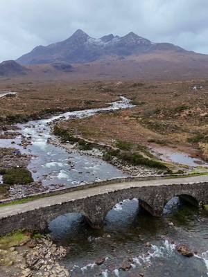 A post by @scotland on TikTok caption: The Old Sligachan Bridge, located on the Isle of Skye, Scotland, is a historic structure built between 1810 and 1818 by engineer Thomas Telford. This three-arched stone bridge, with its distinctive humpback design, was originally part of the main route through Skye. In the 20th century, it was replaced by a modern bridge on the A87 Situated near the Cuillin mountains, the bridge offers stunning views of the surrounding landscapes, making it a popular spot for photographers and nature enthusiasts. The area is also steeped in local legend; it’s said that the waters beneath the bridge possess magical properties. According to folklore, submerging one’s face in the river for seven seconds and allowing it to air dry grants eternal beauty, a tale that adds a mystical allure to the site. #Scotland #ScotlandTikTok #ScotlandTravel #ScotlandForever #TravelTikTok #TravelBucketList #IsleOfSkye #Skye #PlacesToVisit 