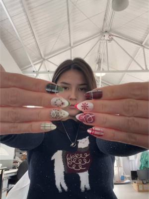 A post by @ronnie.mie on TikTok caption: Company holiday party today… aka an excuse to show off the press on set i painted 🎄💅  #pressonnails #christmasnails #holidaynails 