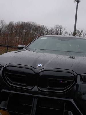 A post by @circlebmw on TikTok caption: The 2025 M5 is finally here! Stop by Circle BMW to see for yourself! 🖤🔥  #m5 #bmw #bmwm #supercar #v8engine #hybrid #black #interior #driving #car #new #fire 