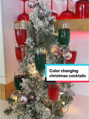 A post by @lorynpowell on TikTok caption: Color changing Christmas cocktails that will really CLAUS a scene. This water delivery service from @ReadyRefresh helps make sure I always have sparkling water stocked for all my cocktail needs. #ReadyRefreshPartner #ReadyRefresh RECIPE: Makes ~12 ornaments (about 5 ounces each) -1 bottle Saratoga Sparkling Water (750ml) -1 bottle sparkling rosé -2 cups whipped vodka -1 cup cranberry juice (more or less depending on your preferred sweetness, but don’t add too much or the color could be too dark) -Mix drink and pour into clear ornaments, about 3/4 full if using champagne flutes -Alternate glasses with 1/8 teaspoon of edible red or green glitter dust  -Place ice cube on top to hide the glitter. (I used stick-shape ice molds that are long so they fit in the champagne flutes. Fill your ice mold with water, lots of cranberries, and top with rosemary sprigs. Make sure the cranberries and rosemary stick out over the water for a fun ice look!) -Set ornaments on top of the champagne flutes -When ready, pour the ornament in your glass and watch as the color is revealed!