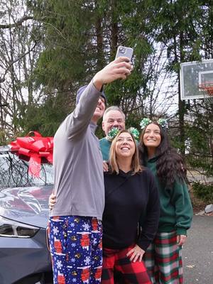 A post by @circlebmw on TikTok caption: Make this holiday season extra special with BMW 🎄✨ ##familytime##holidays##surprise##bow##bmwlife##joy##shocked##red##cheer