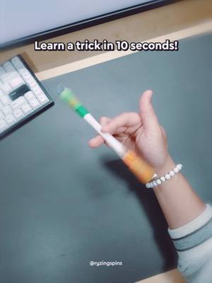 A post by @ryzingspins on TikTok caption: Learn the FINGERPASS pen spinning trick in 10 seconds! 🌀 #tutorial #trick #penspinning #easy #beginner 