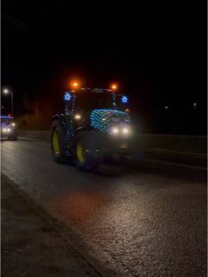 A post by @scotland on TikTok caption: Christmas Eve Tractor Run in Huntly, Scotland 🚜🎄✨ #Scotland #Tractor #TractorRun #Christmas #Farmers 