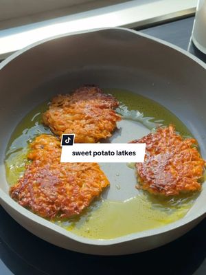 A post by @healthygirlkitchen on TikTok caption: Save the recipe: SWEET POTATO LATKES (vegan + easy) 🕎💙🍠 Happy Hanukkah besties. To those who celebrate, sending you all love and light. I wanted to share this delicious latke recipe with you for sweet potato latkes. They are amazing and so easy to make. Even if you’re not jewish, you gotta make these they are heaven.  ingredients:  2 large sweet potatoes grated 1/2 cup whole wheat flour 1/2 cup JUST egg (vegan egg substitute)  1 small yellow onion pulsed in food processor 1 tbsp cornstarch 1 tsp salt 1 tsp pepper  How to:  1. Mix all ingredients in a bowl until combined.  2. Heat 3-4 tbsp olive oil in a nonstick pan until on medium to high heat then using a cookie scoop, scoop the batter into the pan and flatten with a spatula so they cook evenly.  3. Cook 3-4 minutes per side or until golden brown.  4. Line a platter or plate with paper towel.  5. As they cook, lay the latkes on the paper towel to soak up excess oil.  6. Top with sour cream + chives or apple sauce or both!  7. YUM!  #latkes #hanukkah #jewish 