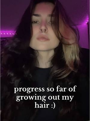 A post by @cybervoyd on TikTok caption: i started growing my hair out officially in 2023. i’ve always had my hair super short, so it’s been nice for a change 🖤  #nonbinary #androgynous 