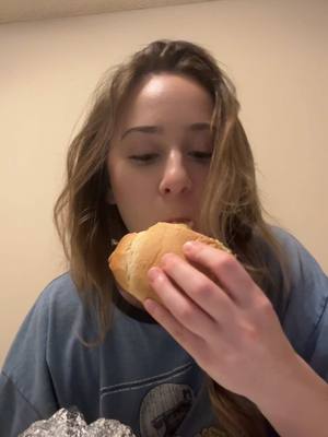 A post by @brookebanana99 on TikTok caption: Don’t mind me just here to eat my half sandwich in bed at 3:30am after serving drinks all night on new years. Cheers 🍾 and it was good