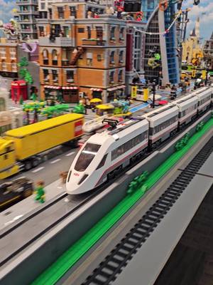 A post by @bricksiej on TikTok caption: Train Zipping Around MASSIVE LEGO CITY!