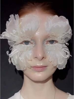 A post by @patmcgrathreal on TikTok caption: FABULOUS FEATHERS ✨✨✨ Major INSPO for the #ShayneOliver fashion week test look. Who’s ready for more iconic fashion week looks this season? ✨✨✨ Shop backstage essentials NOW on TikTok Shop! ✨STARRING✨ Divine Skin: Rose001™ The Essence Skin Fetish: Sublime Perfection The System Skin Fetish: Highlighter + Balm Duo