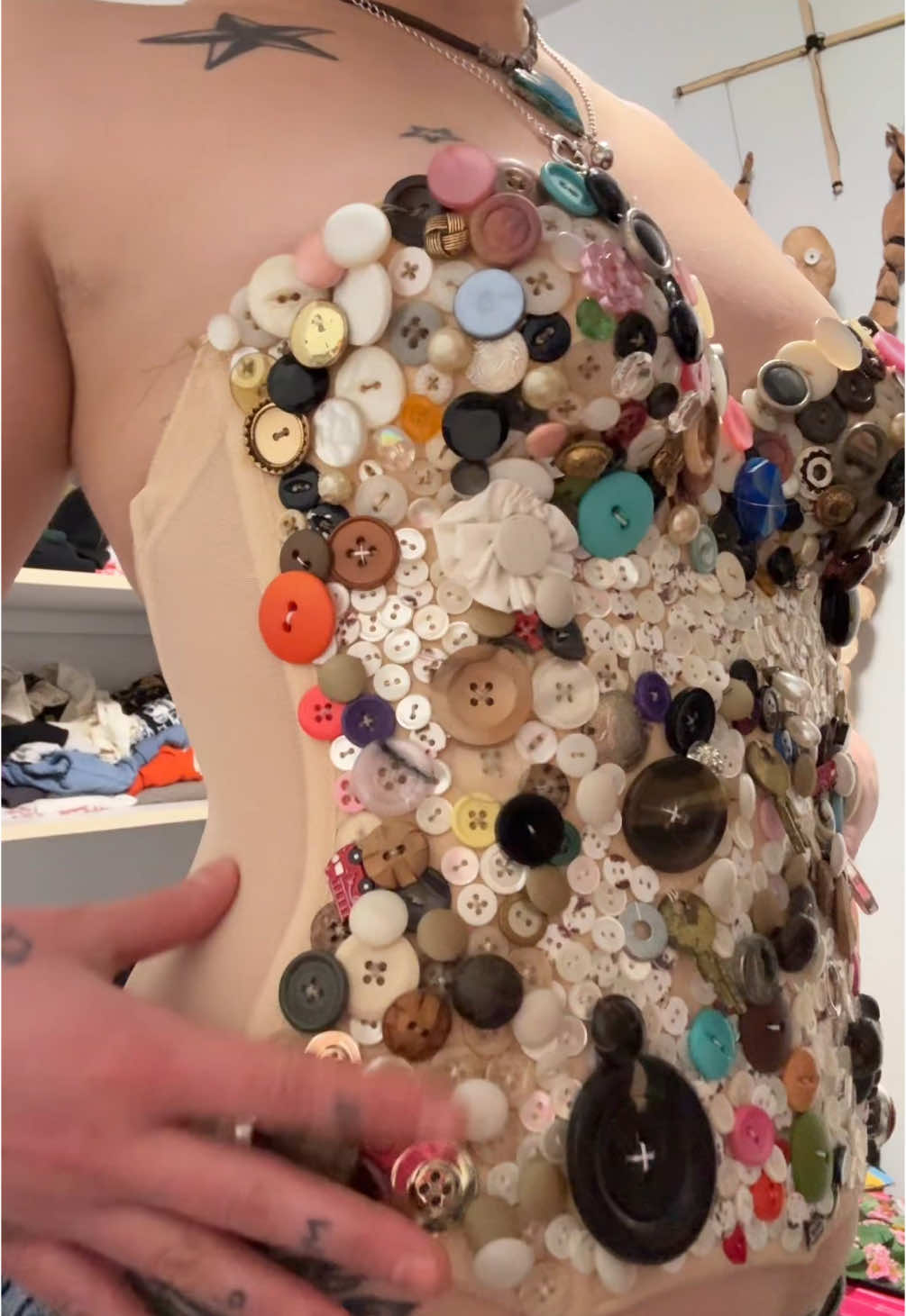 A post by @sydneyl3vy on TikTok caption: dis took like a billion old buttons #upcycle #buttons #thriftflip #sewing #diy 