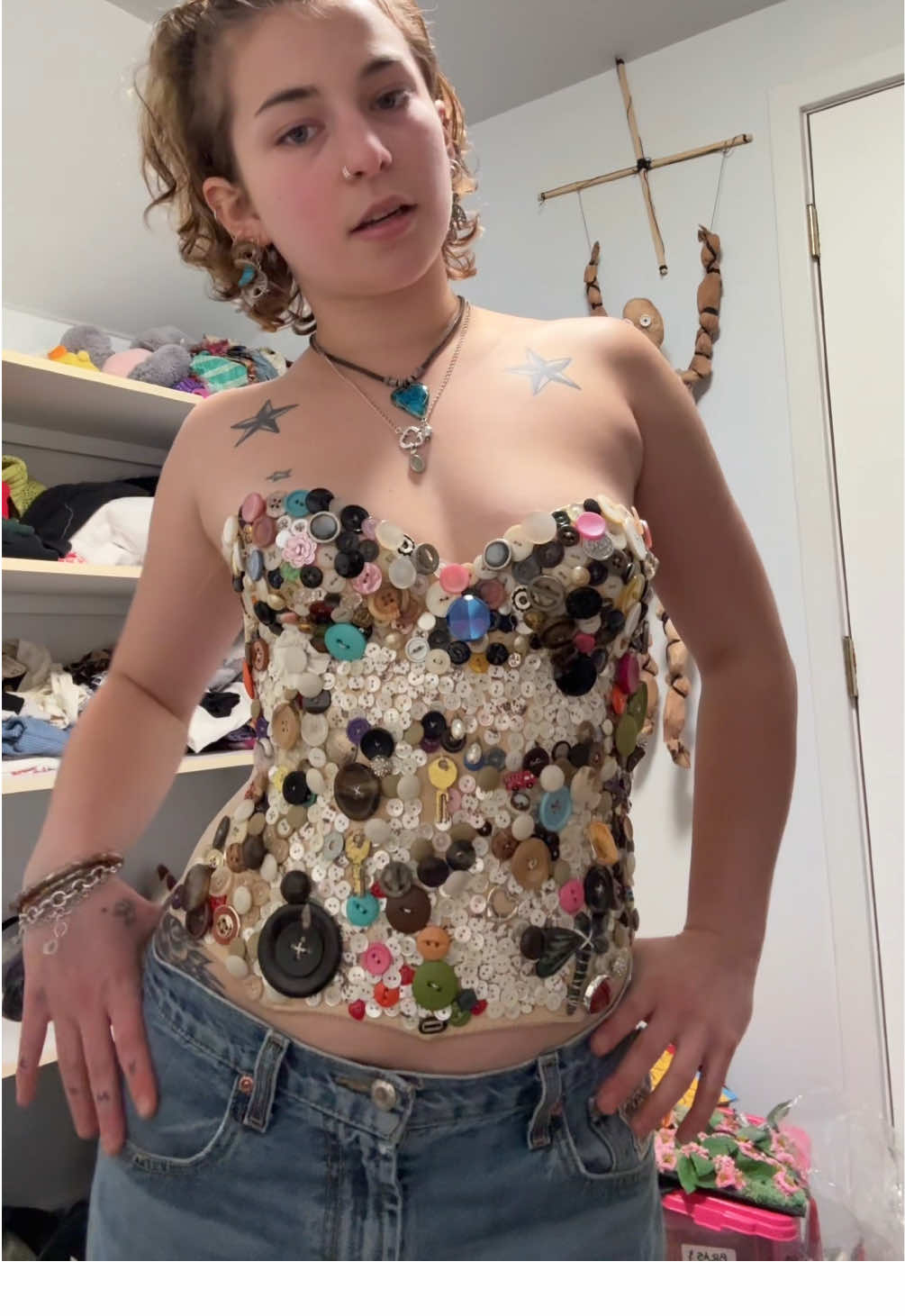 A post by @sydneyl3vy on TikTok caption: DONE TEEHEE this was actually so fun what else should i add #upcycle #sewing #buttons #thriftflip #fashion