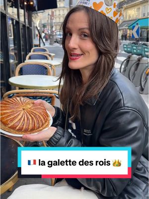 A post by @hellofrenchnyc on TikTok caption: 🇫🇷 La galette des rois is a must-try French pastry in January! 🥮 Layers of buttery puff pastry (la pâte feuilletée) + almond cream (la frangipane), and a hidden charm (la fève) that crowns you king or queen for the day. 👑  Got mine at @maisonkayser in Paris—absolutely délicieux! 💛 Have you ever tried a galette des rois? #GaletteDesRois #KingCake #FrenchFood #FrenchPastry #MaisonKayser #France