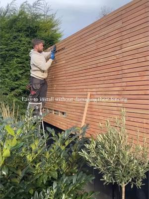 A post by @klk.interiors on TikTok caption: One of the best garden diys we’ve done was to cover the neighbours fencing with these latch slat panels from @Ruby | Home Garden and Timber 🤎 Easy to install without damaging their fencing and totally changes the look of the garden. (We asked for permission first)  *previous pr product  Looking forward to getting back in the garden this year  #garden #gardendesign #gardenfence #gardenfencing #fencing #larchfencing #gardenideas #gardendecor 