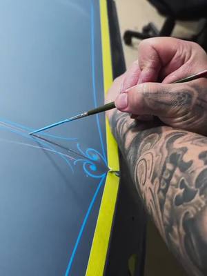 A post by @tropicalglitz on TikTok caption: Mesmerizing freehand pinstriping by the talented #PhillipsFineLines 🎨✨ Watch the magic unfold stroke by stroke! #Pinstriping #CustomArt #CarArt #SatisfyingArt #ArtInMotion #lowrider #lowriders #musclecars #hotrod #musclecar #candypaint #autopaint #lowridercars #rccar #showcars #classiccar #carpaint #pinstriping