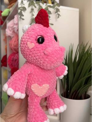 A post by @wondercrochet on TikTok caption: crocheting a valendino 💌🦕 i just couldn’t wait to start making valentines day plushies, one of my favorite themes to make 💕 i made this plush using my dinosaur pattern which will be out this week if you want to make your own cute love dino! #crochet #dino #valentines #handmade #plushie 