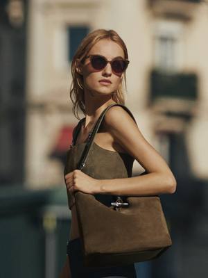 A post by @longchamp on TikTok caption: New Year, New Parisienne, New Le Roseau. In January, Paris moves at its own rhythm, and so does she, with her new Roseau in velvet. Collection: #LongchampLiveGreen With Maartje Verhoef and Akari Higashi #LongchampSS25 #longchampbag #leroseau #ootd #fashion #outfit #parisianstyle