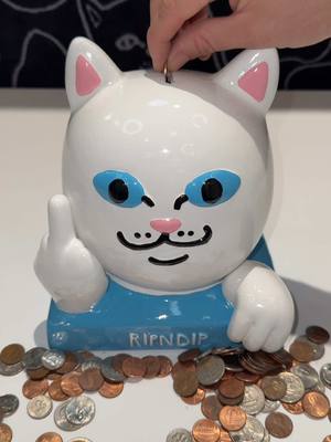 A post by @ripndip on TikTok caption: Lord nermal ceramic coin bank on sale for only $15 that’s 1,500 pennies 🪙