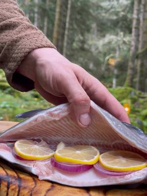 A post by @thenikosknifee on TikTok caption: Salt Crusted Fish by the River 🤤🎣 #outdoorcooking #cooking #fishing #fish #asmrcooking #trout #knifeskills 