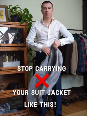 A post by @blakescott_ on TikTok caption: How to properly carry your suit jacket. Who else does this?  #menstyletips #suits #suitstyle #suitjacket 