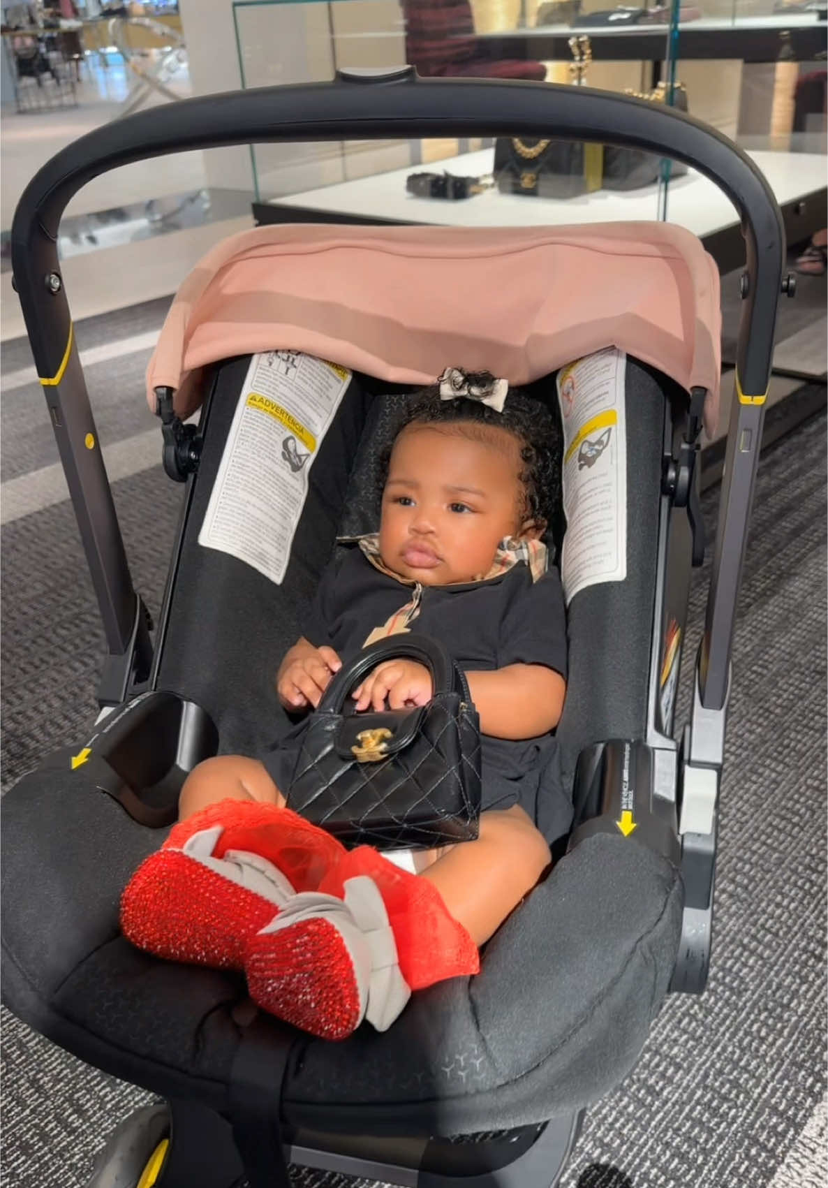 A post by @kashdoll on TikTok caption: Klarity gets her first Chanel bag after getting her ears pierced #fyp #TheLastDoll #luxurylife #momsoftiktok #momlife #Klarity 