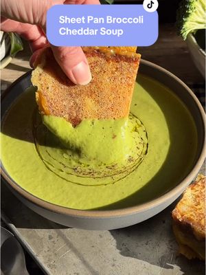 A post by @crowdedkitchen on TikTok caption: Sheet Pan Broccoli Cheddar Soup with Parmesan Crusted Grilled Cheese 😍🥦🧀 the ultimate cozy (and easy!) soup to try this week! RECIPE (4servings)  1 lb broccoli florets  Half of a yellow onion, sliced into 1/2” wedges 1 head of garlic 2 tbsp olive oil 1 tsp mustard powder  1/2 tsp kosher salt  1/4 tsp tsp black pepper  1 tsp nutritional yeast  Pinch of cayenne pepper 3 cups chicken or vegetable broth  1 1/2 cups baby spinach, packed 2 oz shredded cheddar cheese  1 oz shredded parmesan cheese  Preheat oven to 350˚F.  Slice the top off the garlic bulb to expose the cloves. Add broccoli, onion and garlic to a sheet pan. Drizzle with olive oil, then season the broccoli and onion with mustard powder, salt, pepper, nutritional yeast and cayenne. Toss to coat.  Cover the sheet pan with foil and roast for 35-45 minutes, until the broccoli is fork tender and lightly browned.  About 10 minutes before  the vegetables are done, heat the broth in a small pot until it’s very hot.  Right after they come out of the oven, add the roasted vegetables (we use half of the garlic cloves and save the other half for another recipe!), broth, spinach and both cheeses to a heat safe blender and blend until completely smooth. Enjoy warm!  TO MAKE THE GRILLED CHEESE:  Heat 1-2 tbsp of butter in a skillet. Toast two slices of bread in the pan until golden brown on one side. Flip the slices of bread over, then set one piece of bread aside.  Grate parmesan cheese directly on the pan in an oval about the size of the piece of bread. Place the untoasted side of the bread on the parmesan. Top with 2-3 slices of cheddar cheese, then top with the other slice of bread.  Cook until the parmesan side is golden brown, then grate another bed of parmesan next to the sandwich and flip the untoasted side onto the parmesan. Cook until golden brown and crispy. Enjoy with your soup! #soup #soupseason #sheetpan 