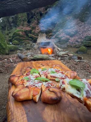 A post by @thenikosknifee on TikTok caption: Star Pizza in a Stone Oven 😍🔥 #pizza #cooking #outdoorcooking #asmrcooking #knifeskills 