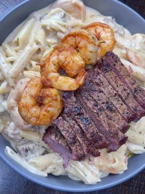 A post by @kay.gorg on TikTok caption: Cajun Creamy Steak & Shrimp Alfredo  Ingredients  - 2 New York strips steak  - Seasonings (Old bay , Slap ya mama, Cayenne pepper, Garlic powder, onion powder, chipotle chili pepper, creole) - Garlic herb butter - Colossal Shrimp  - Penne noodles  - Heavy cream  - Boursin cheese  - Colby jack (Optional) Steak  - Seasonings steak both sides (Old bay , Slap ya mama, Cayenne pepper, Garlic powder, onion powder, chipotle chili pepper, creole) start off with 1 teaspoon of each if you are not comfortable eyeballing  - To your cast iron skillet at 1 tablespoon olive oil just to ensure steak will not stick - Allow skillet to get hot  - Place steak in skillet  - Sear each side 3-4 mins  - After you get a nice sear on both sides rotate additional 3-5mins & bast steak with butter (for better results you can bast steak with garlic & herb butter, Garlic cloves, Thyme & rosemary)  Also keep in mind each temperature on a steak has a different cook time.  - once cooked to desired temperature  - Allow steak to rest  - Once steak has rest cut into cubes  Cajun Shrimp  - Peel , Clean , Devine your shrimp  - Season (Old bay , Slap ya mama, Cayenne pepper, Creole)  - To a pan add 2 tables garlic & herb butter  - Add seasoned shrimp  - Cook shrimp 5-8 mins or until shrimp color changes & curl up Cajun Alfredo Sauce  - to the same skillet you cooked shrimp in add 2 cups of heavy cream  - 1 whole block Boursin cheese  - 1/2 cup of Colby jack (optional) - 1/2 teaspoon Cayenne pepper  - 1/2 teaspoon Chipotle chili pepper  - 1/2 teaspoon slap ya mama  - 1/2 teaspoon old bay  - Mix well until it becomes a sauce consistency  - Add noodles  - Add steak  - Add shrimp  - Add 1/3 cup of Colby jack cheese  - Allow to simmer for additional 5 mins  Enjoy  #fyp #trending #kaikyianna #cooknwkai #cooknwkaikyianna #cajunalfredo #pasta 