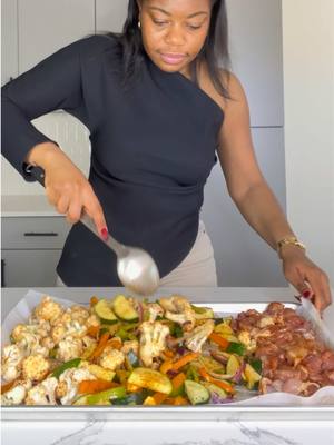 A post by @fayette_nyehn on TikTok caption: Quick and Easy Sheet Pan Meal 😋 Ingredients: 1 medium cauliflower  2 medium zucchini  Half an onion  1 large green bell pepper  1 large orange bell pepper  1 LB. Chicken thighs  Seasonings: 1 tsp garlic powder, 1 tsp black pepper, 1 tsp salt, 1 tbsp smoked paprika, and 1 tsp oregano  #mealprep 