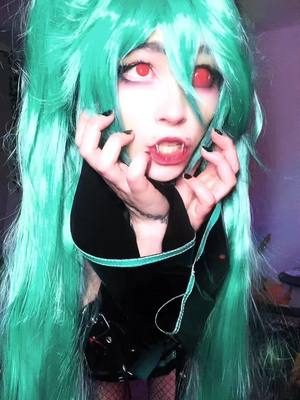 A post by @scapegoat.cos on TikTok caption: jealous of me and bro #hatsunemiku#hatsunemikucosplay#hatsunemikuwig#vocaloid#vocaloidcosplay#angelfangs#angelfangspiercing#projectsekai#projectsekaicosplay#emohatsunemiku#emohatsunemikucosplay#calneca#calnecacosplay#calnecamiku ig im the emo miku with angel fangs