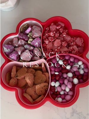 A post by @elysian.living on TikTok caption: Heart snack box restock 💌 #snackbox #asmr #heart #restock #restockasmr #satisfying #organizedhome #organization #candytok #snacks #chocolate #valentine #pink 