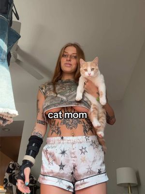 A post by @mangybaby on TikTok caption: just a cat mom #fyp #orangecat #accountant 