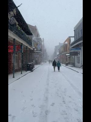 A post by @mikesweatherpage on TikTok caption: It's currently snowing on Bourbon Street in New Orleans! 