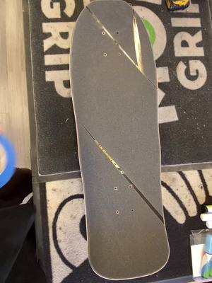 A post by @seanbolis on TikTok caption: Drawing a multicolor design on my griptape using blue tape then removing the tape.  I wanted it to match the skateboard wheels.