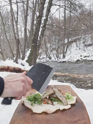 A post by @thenikosknifee on TikTok caption: Chicken Kebab in the Snow 😍🔥 #chicken #outdoorcooking #asmrcooking #cooking #kebab 