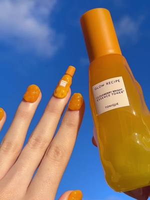 A post by @glowrecipe on TikTok caption: reminiscing about when @Soph created these incredible Cloudberry Bright Essence Toner nails 🧡 #glowrecipe #trendingskincare #nailart #nails #glowingskin 