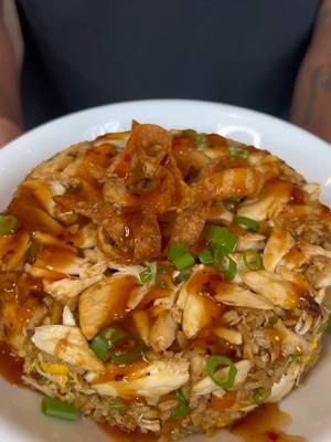 A post by @eatwitzo on TikTok caption: Any type of fried rice is always a vibe! I was trying to replicate a mixture of a crab rangoon and a traditional fried rice, safe to say we executed perfectly 🔥 Enjoy!  Full ingredient list:  1 lb lump/jumbo lump crab meat  2-3 tbsp butter 1 tbsp oyster sauce  2 tbsp - 1/4 cup soy sauce  1-2 tsp sesame oil (optional)  2-4 cups day old white rice 1/4 cup diced onions 4 large garlic cloves minced 1/4-1/2 cup peas/carrots frozen  3-4 medium eggs Pepper to taste (if preferred)  Wonton strips  Frying oil of your preference  For sweet chili sauce:  1/4 cup-1/2 cup ketchup 1/4 cup-1/2 cup pineapple juice 1/4 cup-1/2 cup white sugar  1/4 cup vinegar  1/4 cup soy sauce Cornstarch slurry (1 tbsp cornstarch 3 tbsp water)  Red pepper flakes to taste (for heat)