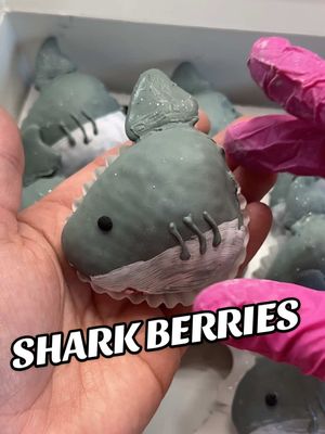 A post by @berrylicioussweets on TikTok caption: Easy shark berry tutorial 🦈🩵 #shark #strawberry #chocolate #baking #cakedecorating 