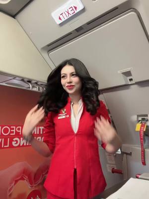 A post by @malytaheng on TikTok caption: Don’t need Red dress for Chinese new year~ I already got my red uniform😂♥️✈️ #cambodia #khmer #fyp #AirAsia #AirAsiaCambodia #cabincrew #airasiacabincrew 