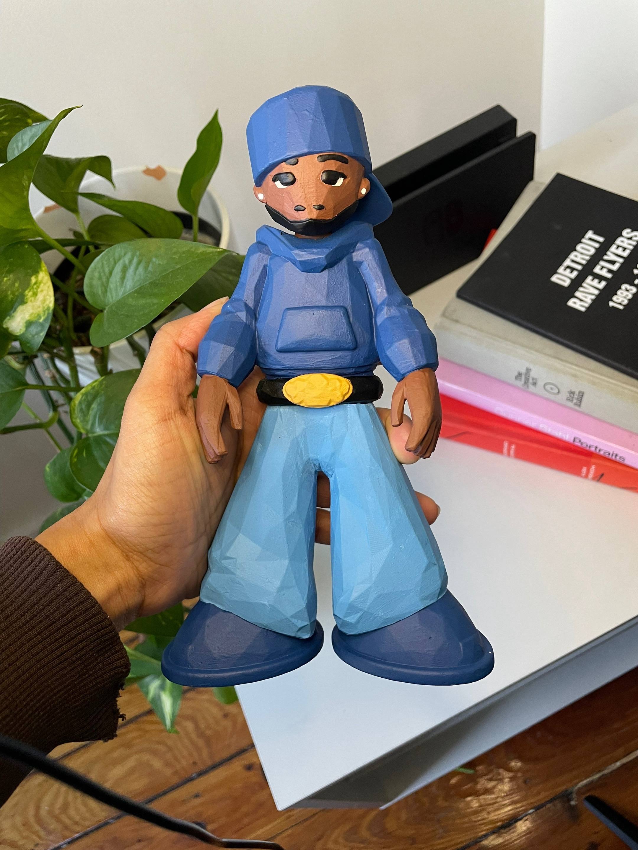 A post by @visualsbyjada on TikTok caption: This is the art toy I made of Kendrick Lamar #arttoy #figurine #resin #art #3dprinting #3dprint #kendricklamar #squabbleup #artistsoftiktok #fyp 