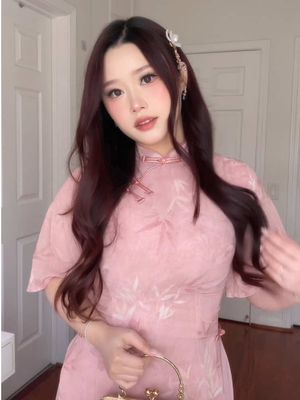 A post by @mochi.chuu on TikTok caption: lunar new year outfit🌸 #OOTD #lunarnewyear #tet #cheongsam #2025 #newyearoutfit #lunarnewyearoutfit 