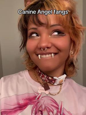 A post by @shibapup4eva on TikTok caption: Got some new spikes for my angel fangs to feel more canine!!! ##kemonomimi #puppygirl #angelfangs #peircing 