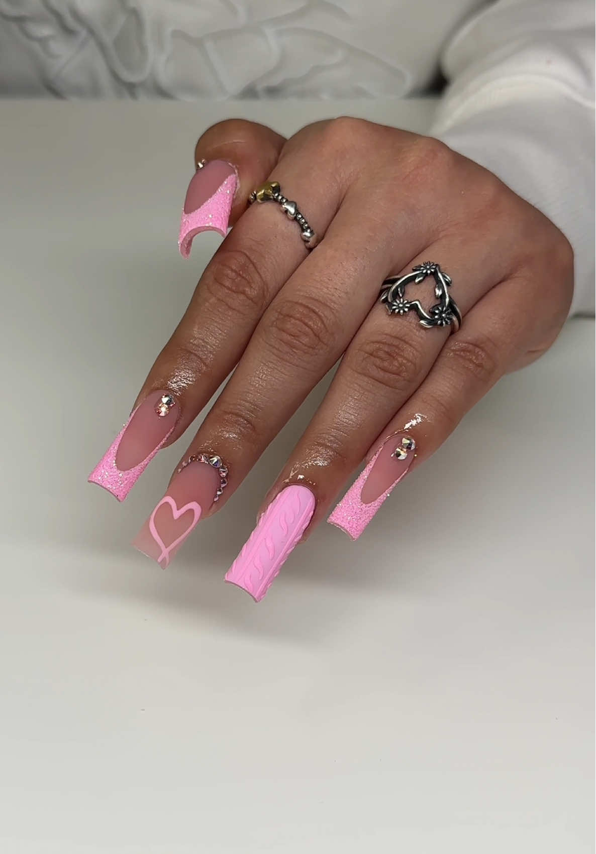 A post by @thanailldoll on TikTok caption: Pink Valentine’s Day nails 💕 Discounts for the girls ☺️🎀 @Lé Moné Thenailldoll  @Ana Does Nailz Linda10 #pinknails #valentinesday #workwithme #glitter #foryoupage #fypシ゚viral #houstontxnailtech #galvestonnailtech #luxurynails #tiktok #nailtech 
