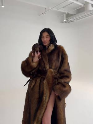 A post by @kyliejenner on TikTok caption: just dropped this fab faux fur coat and more on khy.com !!!