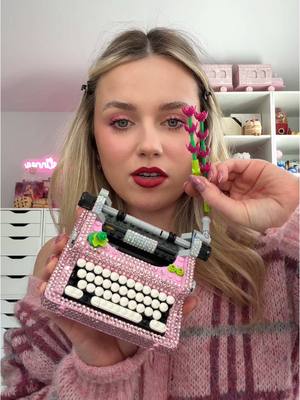 A post by @yannareads on TikTok caption: Typewriter lego has been officially bedazzled ✨📚🌷 #books #BookTok #lego 