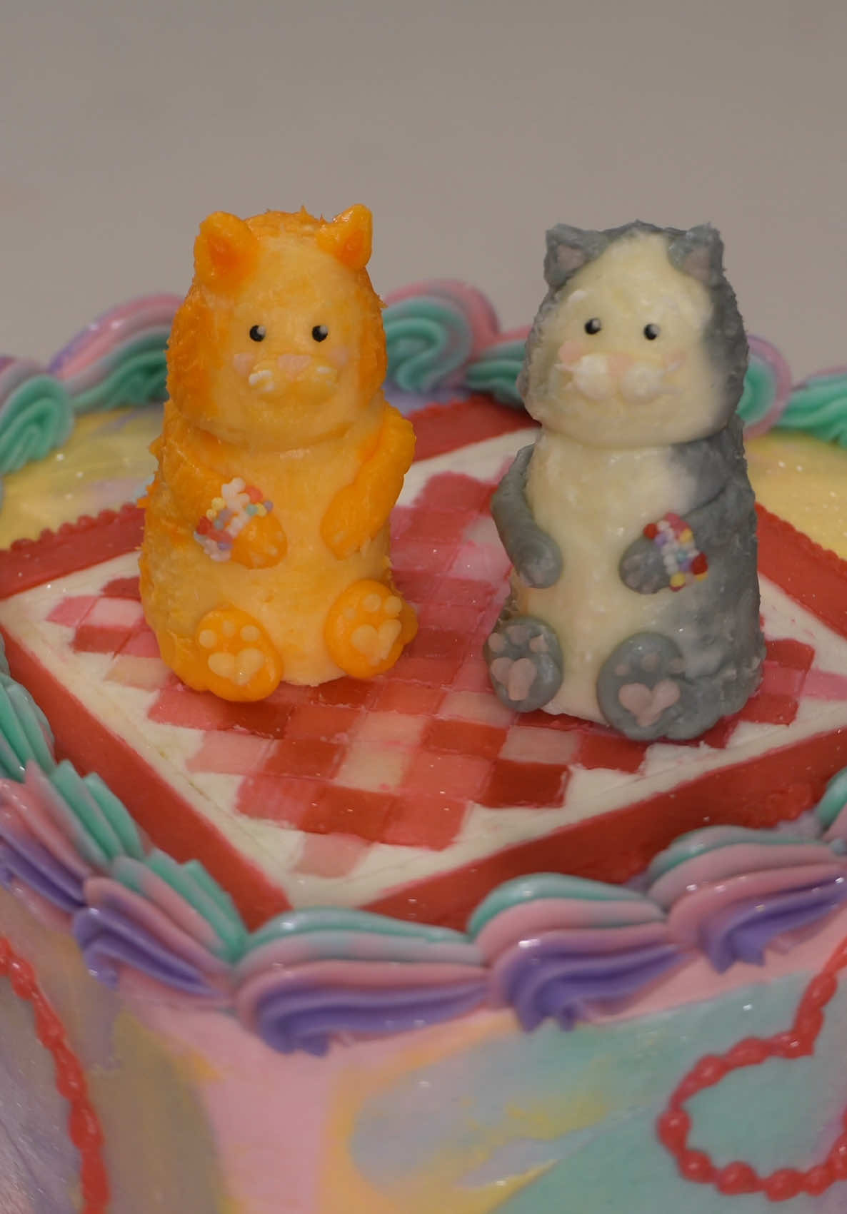 A post by @savsgotcake on TikTok caption: Cats, Quilting and Friendship Bracelets all on a Cake🐈💗✨  #cakedecorating #cakedecorator #taylorswiftcake #friendshipbracelets #catcake #cakeideas #buttercreamcake #cake 
