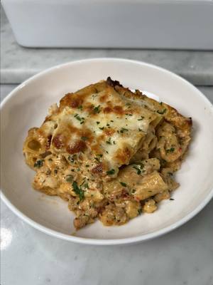 A post by @emmanuelduverneau on TikTok caption: Spicy Tuscan Chicken Pasta Bake  Recipe: 1 box (1 lb) rigatoni or ziti pasta, cooked until almost al dente  Cheese Mixture: 15 oz ricotta cheese 1 cup mozzarella cheese, shredded  1/2 cup Parmesan cheese, grated 1 tsp Italian seasonings  1/4 cup parsley, chopped -Add all ingredients to a bowl and mix until fully combined. Set aside. Chicken mixture: 2 Tbsp olive oil 1 lb ground chicken 1 onion, diced 1 Tbsp Calabrian chili paste salt and pepper to taste  Italian seasoning -In a high rimmed skillet over medium heat, add olive oil. Add onions, salt, and pepper. Mix until translucent. Add Calabrian chili and Italian seasoning and mix. Add the ground chicken, breaking it apart. Fully cook and set aside.  Tuscan sauce:  1 1/2 cups chicken broth 1 cup heavy whipping cream 1 tsp smoked paprika 1 tsp garlic powder  1 tsp Italian seasoning  1 Tbsp Calabrian chili paste 1 cup Parmesan cheese, grated  1 cup spinach, chopped 1/2 cup sun-dried tomatoes  -In a sauce pan over medium heat, add chicken broth, heavy whipping cream, smoked paprika, garlic powder, Italian seasoning, Calabrian chili paste, and Parmesan cheese. Whisk often for 10-20 minutes until sauce thickens.  -Add spinach and sun-dried tomatoes. Simmer until spinach begins to wilt.  -Add the sauce to the chicken and mix to combine. -Add 2/3 of the ground chicken sauce to the pasta along with the ricotta mixture. Mix to combine. The remaining sauce will be used below.  Layering: 1 1/2 cups mozzarella cheese, shredded 1 cup Parmesan cheese, grated -In the bottom of a 9x13 baking dish, add a layer of chicken sauce. Then add a layer of pasta, mozzarella cheese, and Parmesan cheese. Repeat a second time so all sauce, pasta, and cheese has been used. -Preheat oven to 350°F and bake for 25 minutes. Then broil for 3-5 minutes until cheese is slightly browned and bubbly. Enjoy! #food #chicken #EasyRecipe #pasta 